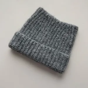 Macro view of textured gray knit beanie featuring a charming cat ears design for women