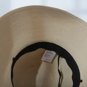 Detail view of the interior tag showing size 57.5cm and 80% paper material composition