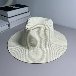 Close-up of a classic cream-white woven Panama straw hat for beach sun protection.