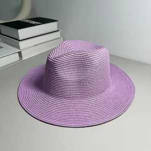 Detailed view of a purple hand-woven Panama straw hat with a wide brim for beach sun protection