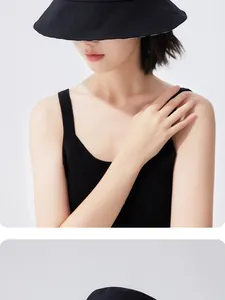 Asian female model wearing a stylish black wide-brim bucket hat for sun protection