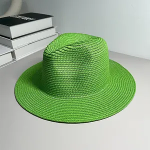 Detailed view of a vibrant green woven straw Panama hat with a wide sunshade brim
