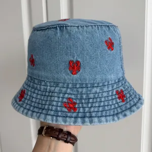 Denim bucket hat featuring intricate red lobster embroidery for summer sun protection.