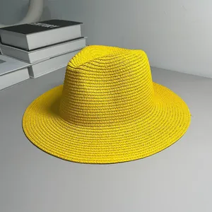 Detailed view of a vibrant yellow straw Panama hat with a textured weave and jazz brim.