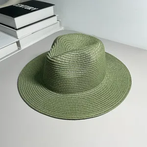 Detailed close-up of a green woven straw Panama hat showing fine spiral textures