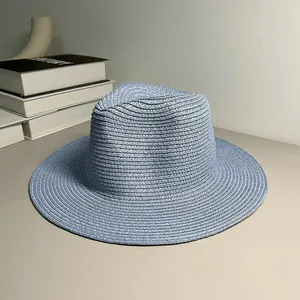 Detail of light blue woven Panama straw hat with a wide brim for sun protection.