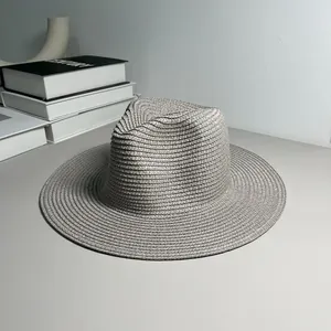 Detailed macro shot of the fine weave on a grey Panama style straw beach sun hat