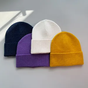 Gruppe von vier bunten gerippten Strickmützen in Marineblau, Lila, Creme und Senfgelb