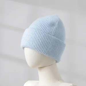 Detail view of light blue knitted rabbit fur beanie showing the soft thick ribbed texture