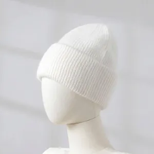 Side detail view of a soft white rabbit hair knit beanie for women on a mannequin.