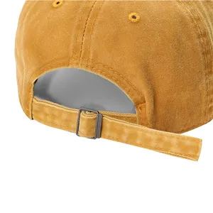 Close-up of adjustable metal buckle on mustard yellow washed baseball cap
