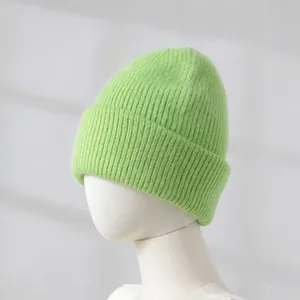 Neon green rabbit fur knit beanie shown on a white mannequin head close-up detail