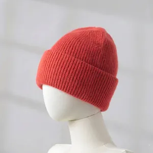 Close-up detail of thick red rabbit hair knitted beanie with ribbed texture