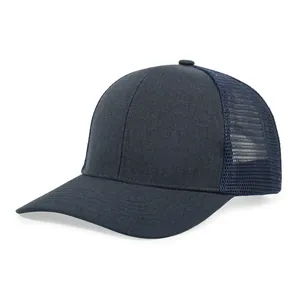 Detail of navy blue trucker cap showing breathable mesh and durable fabric texture.