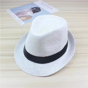 Close-up of a classic white woven straw fedora sun hat featuring a black ribbon band
