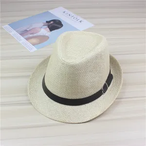 Classic cream straw fedora sun hat with black belt buckle trim on a wooden table