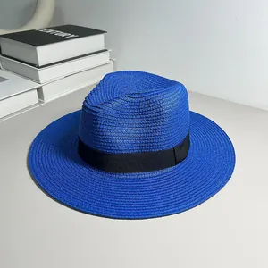 Close-up of a blue woven Panama straw hat with a black ribbon band.