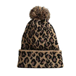 Fashionable leopard print knitted beanie with a fluffy pom-pom for winter warmth and style
