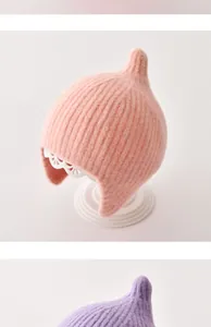 Gedetailleerd macrobeeld van de zachte gebreide textuur van deze babymuts met oorkleppen