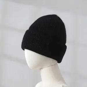 Close-up of black rabbit fur beanie on mannequin showing thick knit texture