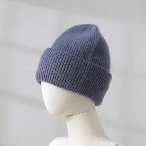 Macro view of a soft blue rabbit fur blend knitted beanie on a mannequin head
