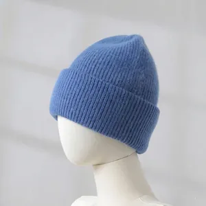 Close-up of blue rabbit hair knitted beanie showing soft texture and ribbed cuff detail.