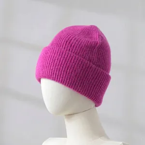 Detailed macro view of magenta rabbit hair knitted beanie worn on white mannequin head