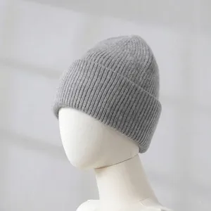 Close-up detail of a soft grey rabbit hair knitted winter beanie hat for women on mannequin