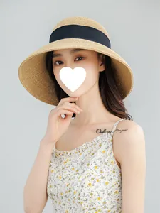 Detailed view of women's wide-brim straw hat with UV protection for summer beach wear