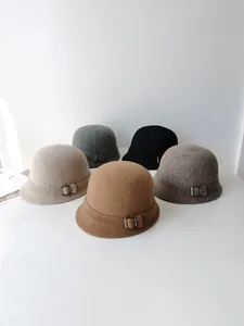 Group of elegant wool felt bucket hats for women displayed in various vintage colors