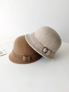 Macro view of two vintage French style wool felt bucket hats in brown and oatmeal colors