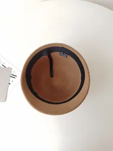 Macro view showing the internal label and wool texture of a brown bucket hat