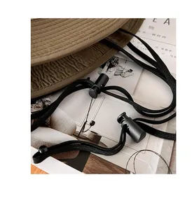 Detail view of the adjustable windproof drawstring and toggles on khaki sun hat