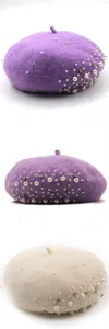 Detailed view of elegant pearl and rhinestone embellishments on soft wool beret hats