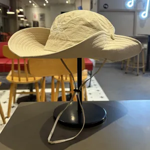 Detailed side view of a beige outdoor sun hat with LOCALBIRD embroidery and strap