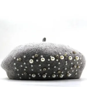 Elegant grey wool beret decorated with white pearls and sparkling rhinestones for winter