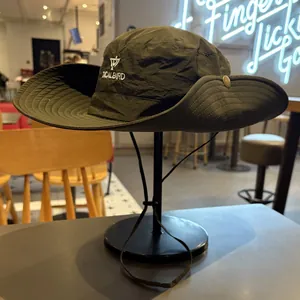 Detailed view of a dark green outdoor sun hat with TICALBIRD embroidery and wide brim