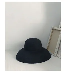 Elegant black wide-brim straw hat in French Hepburn style for summer beach sun protection