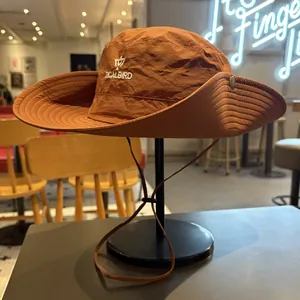 Detail view of a brown outdoor sun hat with embroidered logo for hiking and camping.