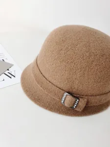 Close-up of elegant camel wool bucket hat featuring a rhinestone-embellished buckle