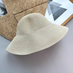 Detailed view of the minimalist woven texture on a foldable straw beach bucket hat.