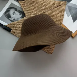 Elegant brown foldable wide-brim woven straw sun hat for summer beach vacation protection