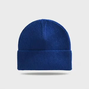 Detail view of the ribbed texture on a solid blue winter knit beanie hat