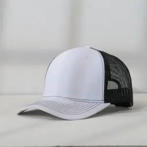 Detailed close-up view of a blank white and black mesh trucker hat for embroidery