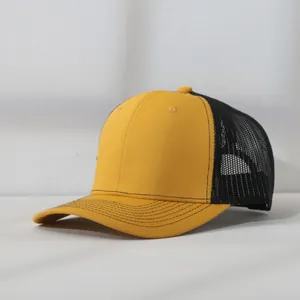 Detailed side view of a two-tone mesh trucker baseball cap in yellow and black