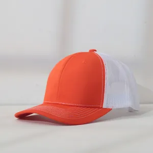 Detail view of an orange and white mesh trucker cap with breathable summer design.