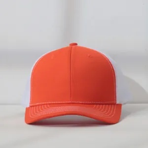 Close-up of a two-tone orange and white mesh trucker hat with detailed stitching
