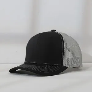 Side view of a two-tone trucker hat featuring black fabric and grey breathable mesh