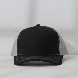 Front view of a black and gray mesh trucker hat featuring contrast stitching details.