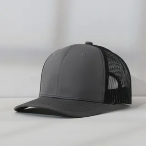 Professional close-up side view of a minimalist grey and black mesh trucker baseball cap